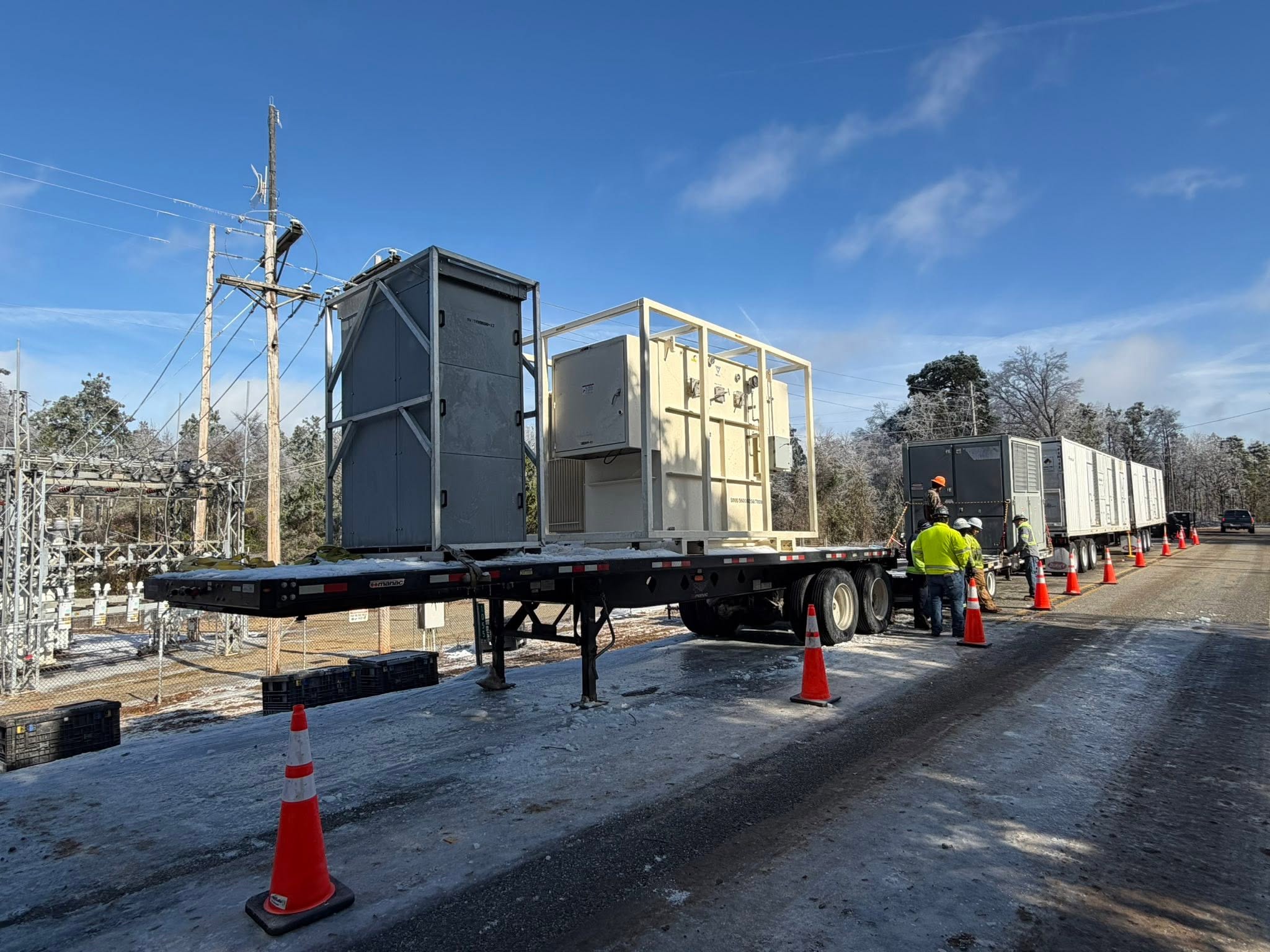 Large power equipment being delivered by trailer