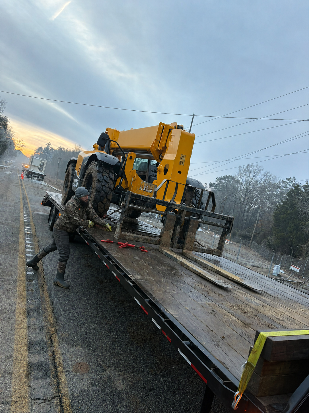 Field crew unloading heavy equipment